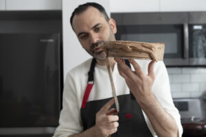 Chef Dominique frosting a cake